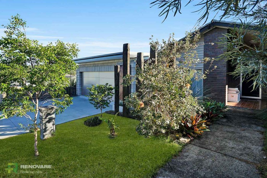 A side view of the exterior of a grey brick house with a garden | Featured image on Renovare Mt Gravatt